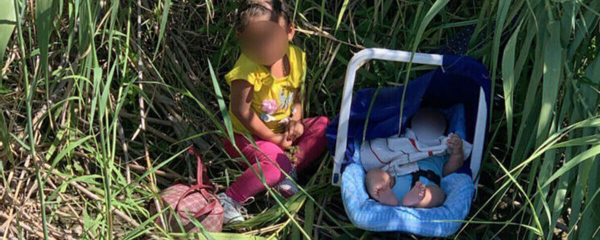 Deux très jeunes enfants retrouvés seuls dans les herbes hautes au bord d’un fleuve